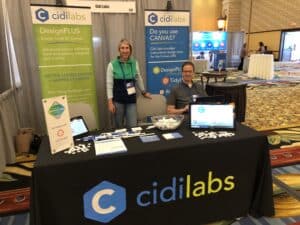 Cidi Labs conference booth with smiling employees