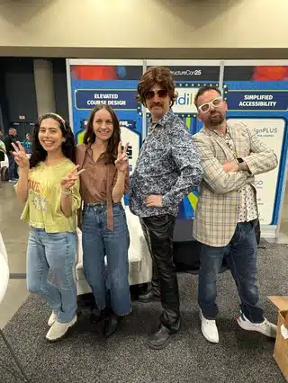 Four Cidi Labs Team members dressed up in 70's style clothing