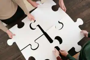 Team putting large puzzle pieces together