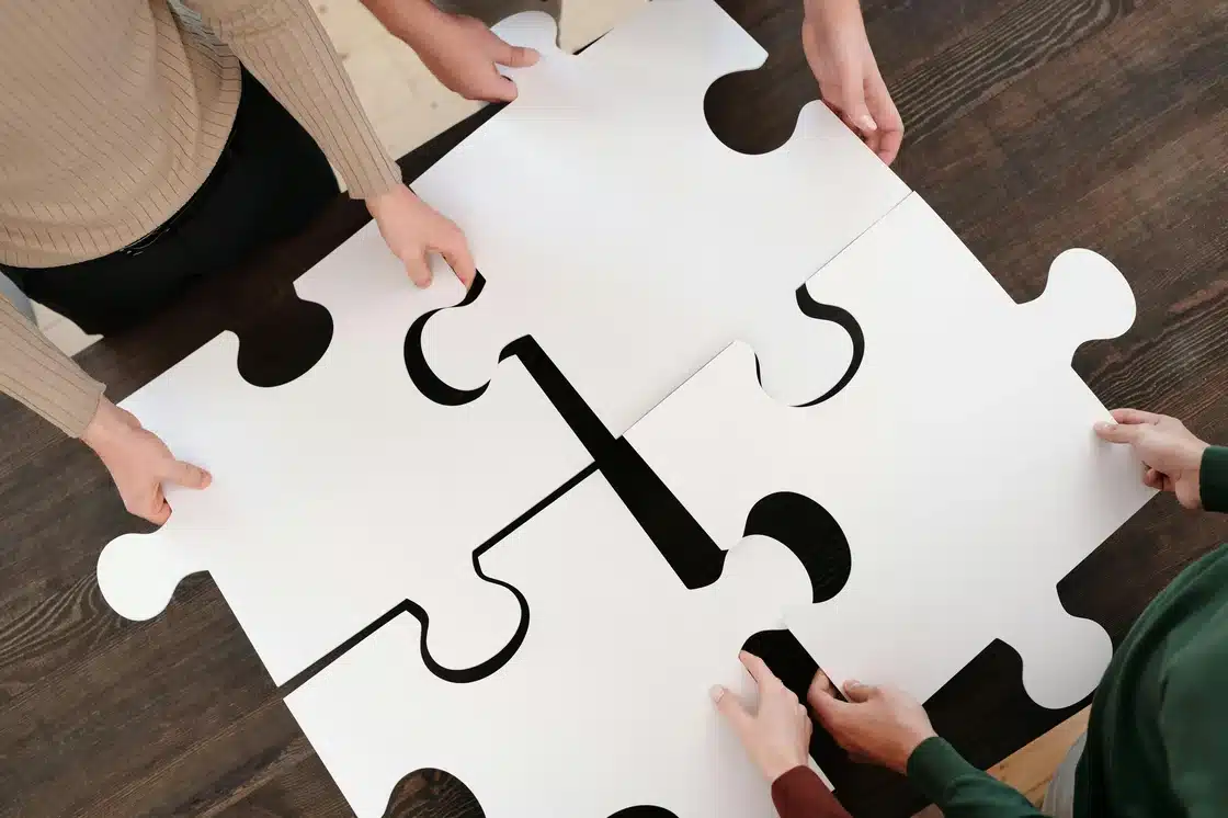 Team putting large puzzle pieces together