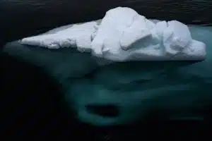 the tip of an iceberg and the portion below the surface visible